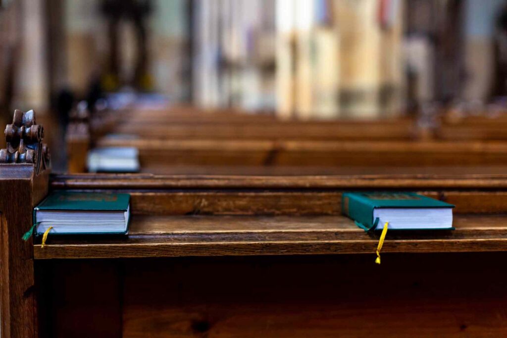 Bible sitting on a pew in a Christian church.