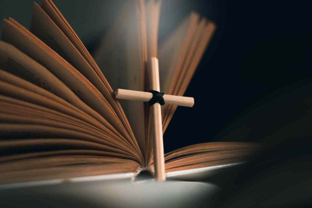 The cross of Jesus next to an open Bible.